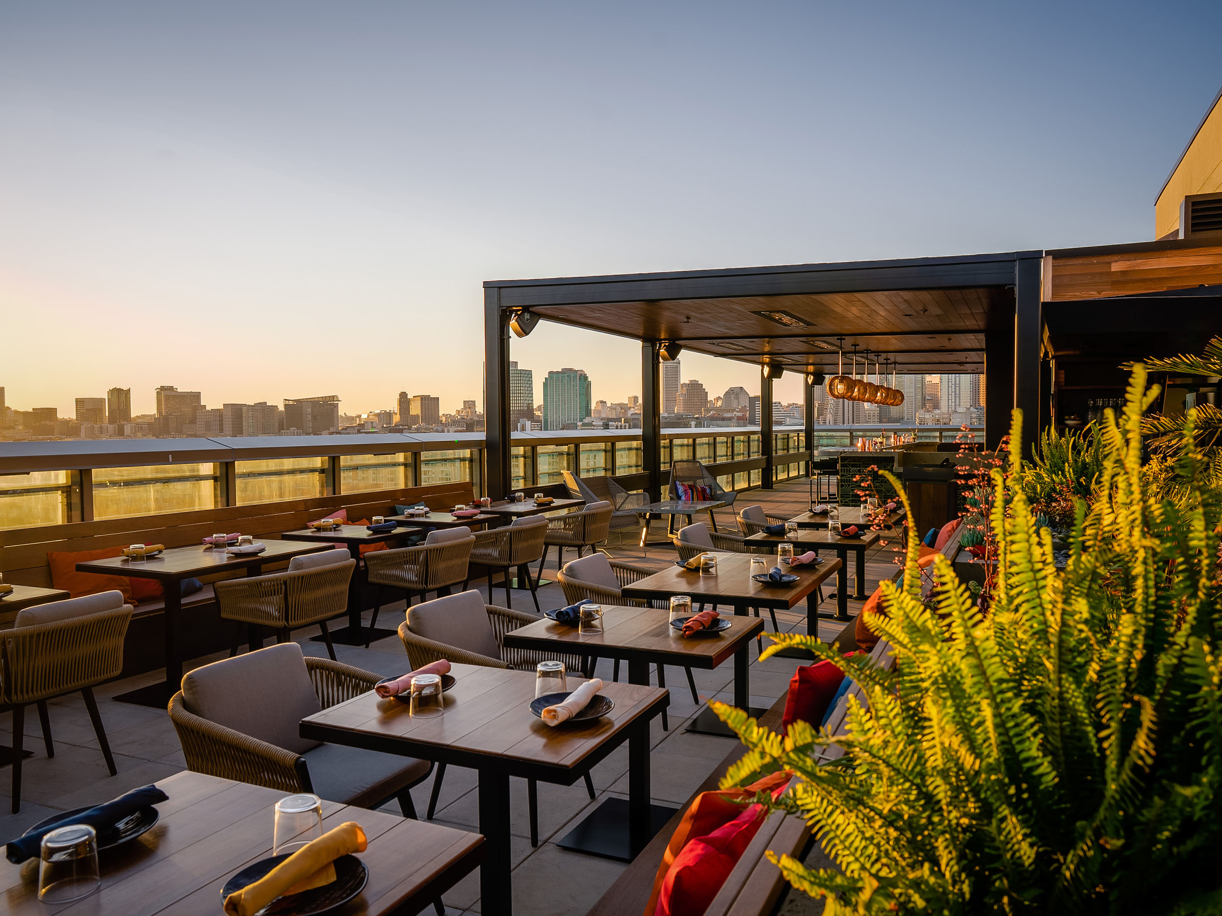 Vibrant rooftop bar at Kaiyo, offering tropical-inspired decor and panoramic views of the San Francisco skyline.